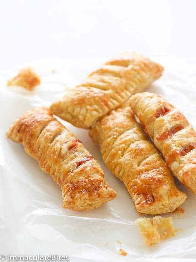 Several pastries sitting on a piece of baking paper. 