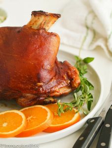 Pernil (Puerto Rican Roast Pork) with sliced oranges