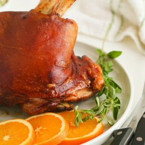 Pernil (Puerto Rican Roast Pork) with sliced oranges