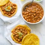 Assembling the flatbread and chickpeas for insanely delicious doubles