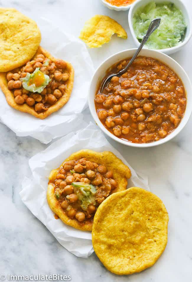 Assembling the flatbread and chickpeas for insanely delicious doubles