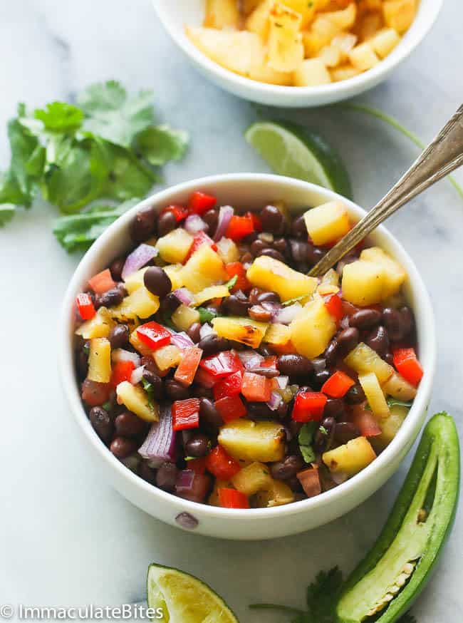 A Bowl of Grill Pineapple Black Bean Salsa with a Slice of Jalapeno