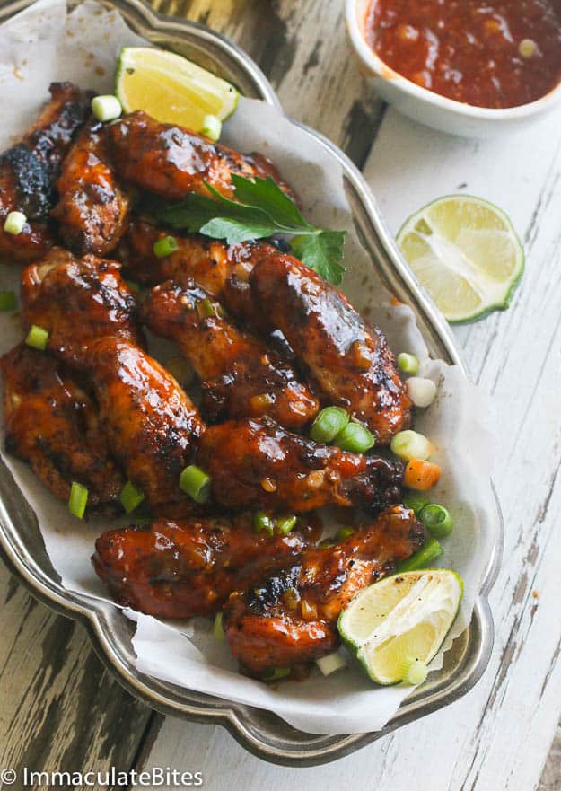 Sticky Sweet and Spicy Caribbean Chicken Wings with Lime Wedges on the Side