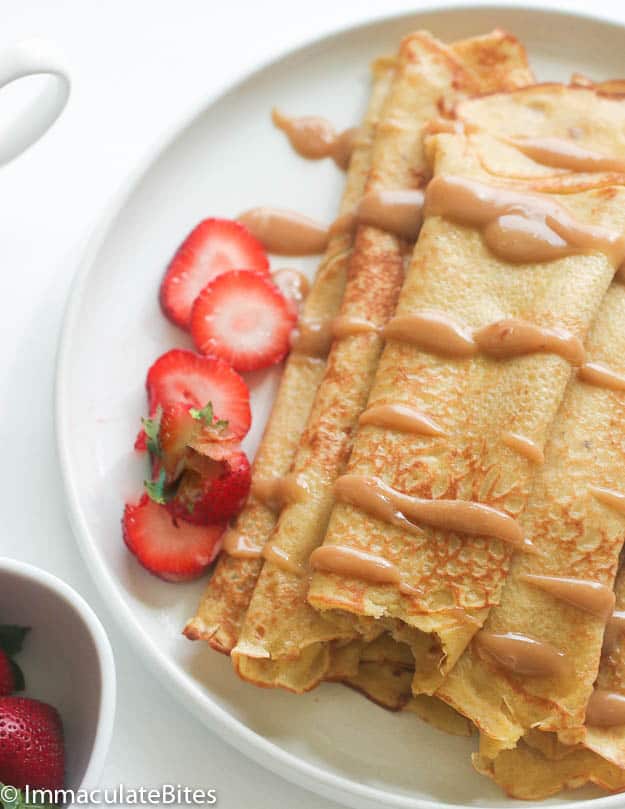 Plantain pancakes with Sliced Strawberries on a Plate