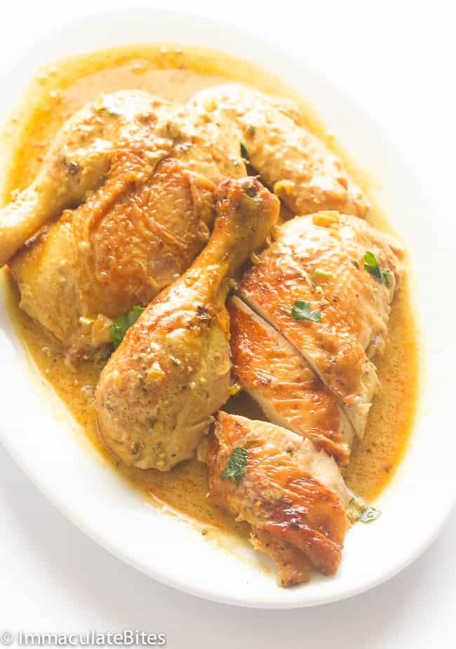 Carved braised chicken with coconut milk on a white platter