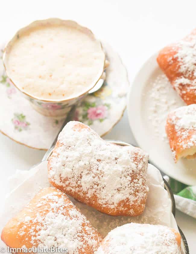 Powdered sugar dusted New Orleans Beignets served with warm coffee