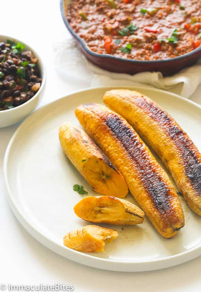 Baked plantains served with meat stew and black beans