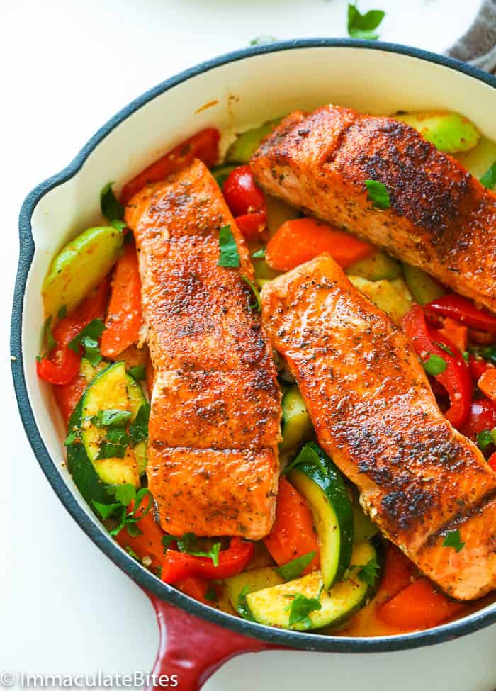 Blackened salmon on a bed of sauteed veggies with Cajun seasoning