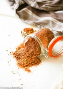 Creole Seasoning spilling beautifully from a jar