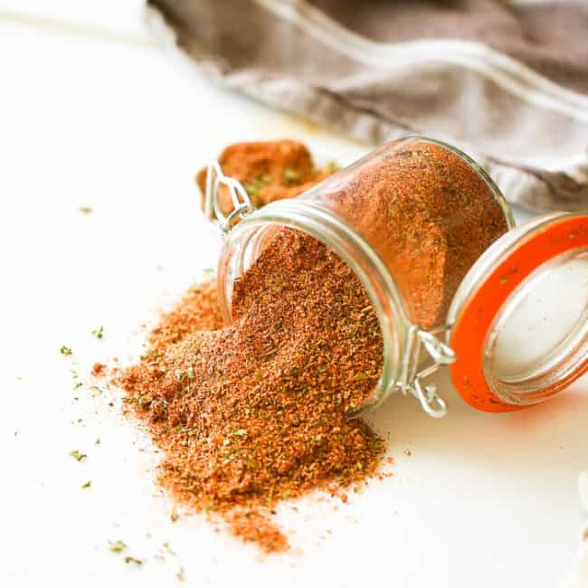 Creole Seasoning spilling beautifully from a jar