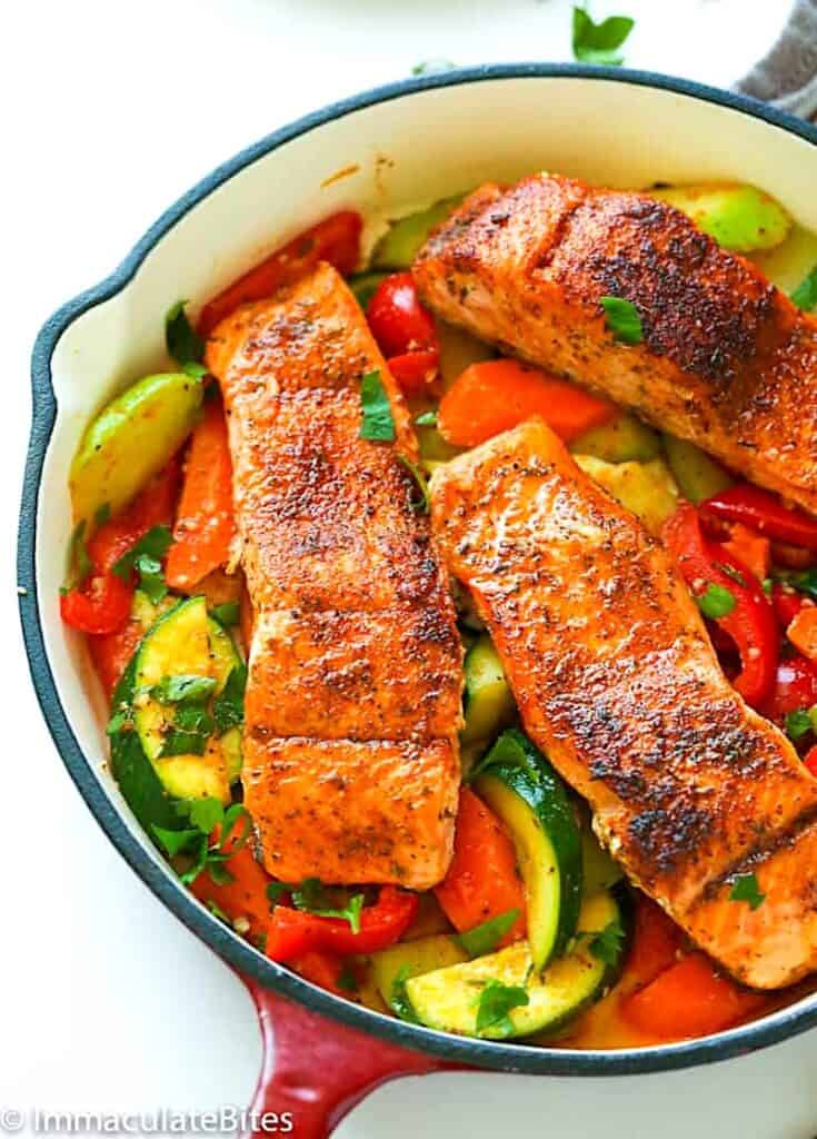 Colorful sauteed vegetables topped with blackened salmon.