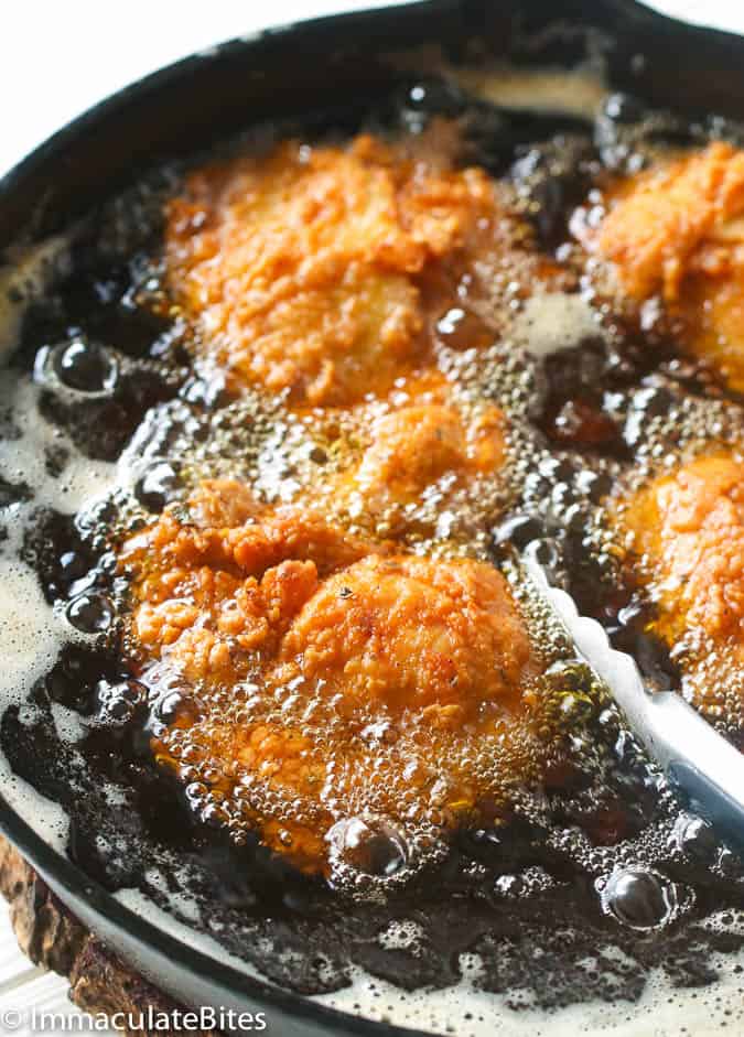 Southern Fried Chicken frying in a cast iron skillet