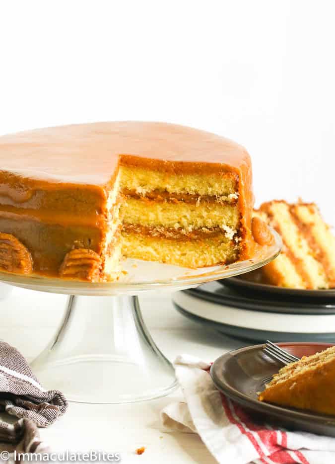Sliced Caramel Cake with Two Individual Slices in the Background