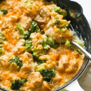 A Pan of Chicken Rice Broccoli with a Ladle to Scoop it Out