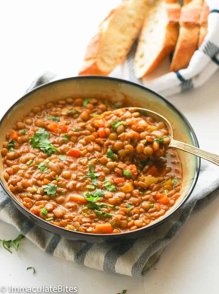 A Plate of Lentil Soup with Baguette Slices in the Background