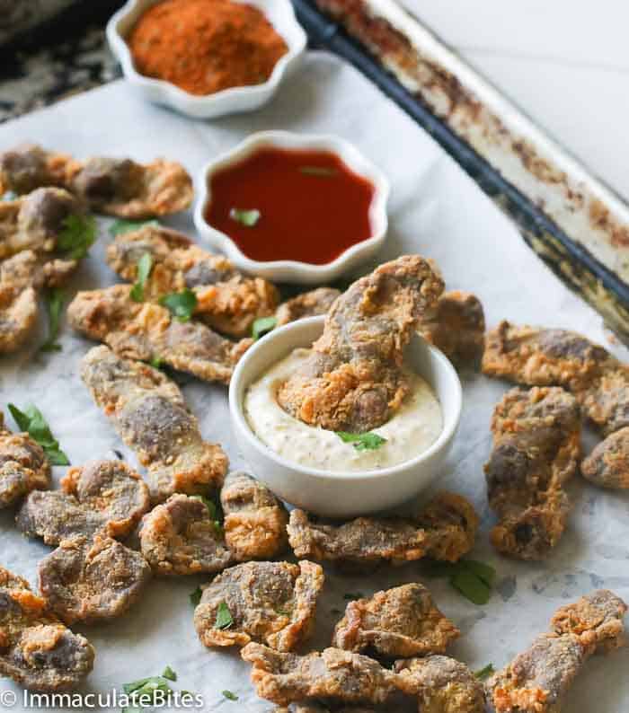 Fried chicken gizzards on a baking pan