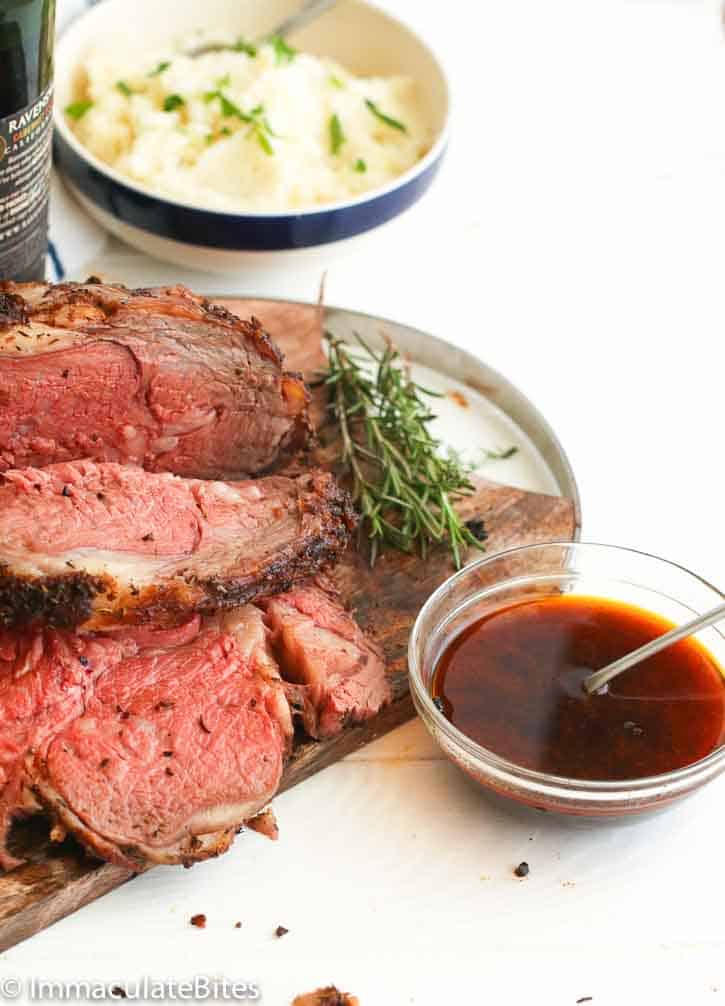 Carving prime rib roast and serving it with flavorful au jus