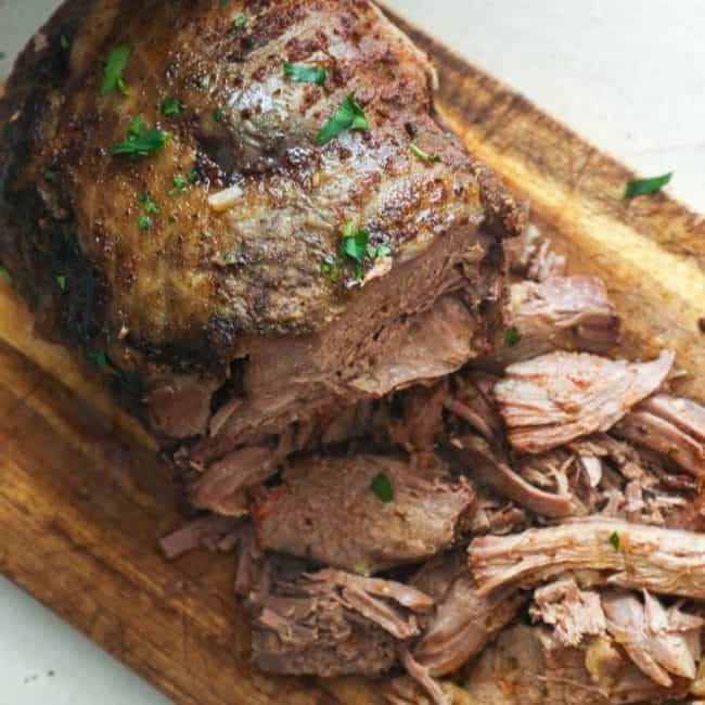 Slow Cooker Lamb Leg on a Chopping Board