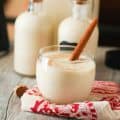 Chilled Coquito with a cinnamon stick for the perfect holiday drink