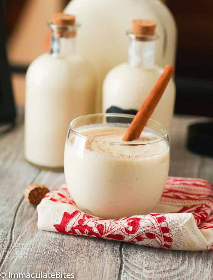 Chilled Coquito with a cinnamon stick for the perfect holiday drink