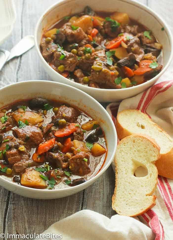 Insanely good slow cooker beef stew with homemade garlic bread to soak up every last drop