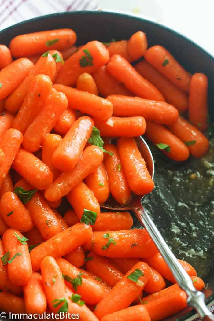 Honey Glazed Carrots in a Pan Being Spooned Out
