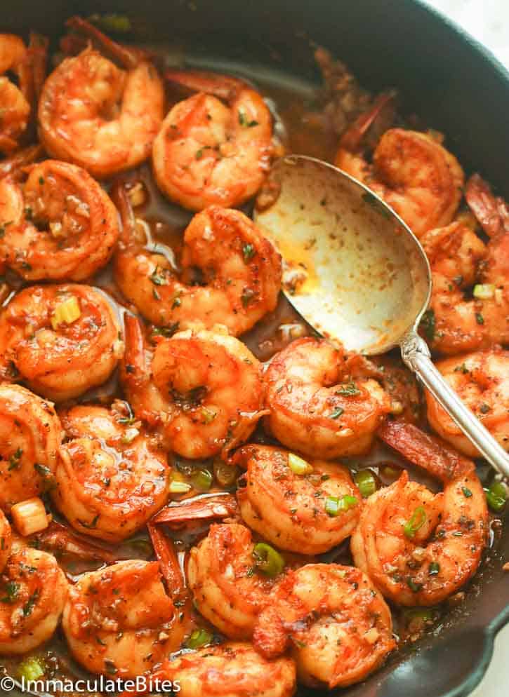 One-Pan New Orleans BBQ Shrimp Garnished with Slices of Green Onions