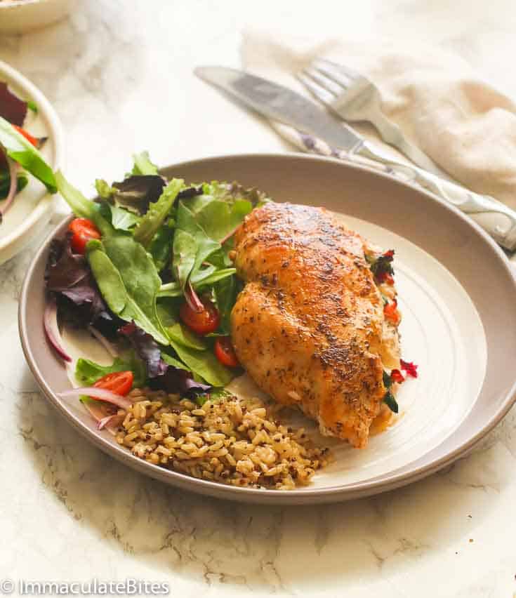 A Stuffed Chicken Breast with baby greens salad and seasoned rice