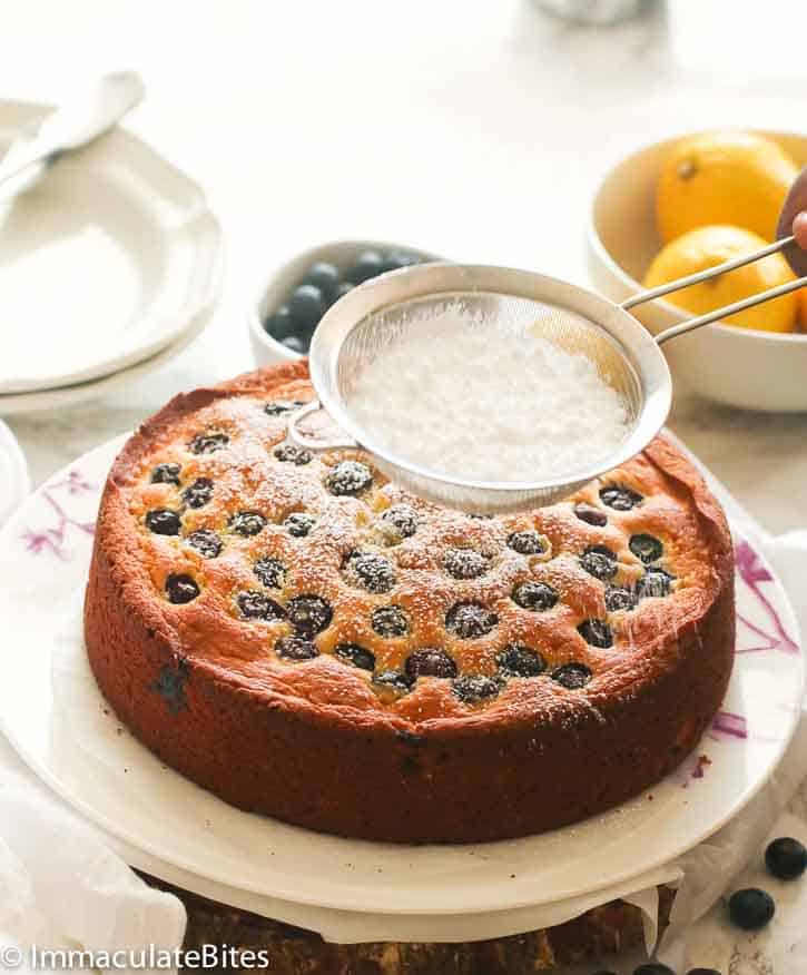 Dusting your lemon blueberry pound cake with powdered sugar. Yum!