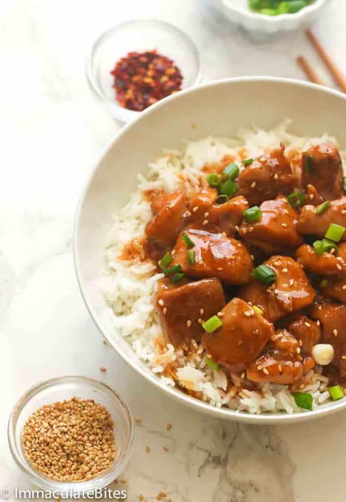 Enjoying a serving of bourbon chicken over white rice