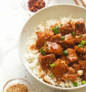 Enjoying a serving of bourbon chicken over white rice