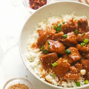 Enjoying a serving of bourbon chicken over white rice