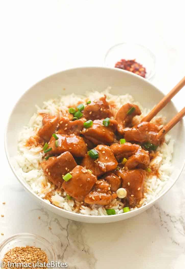 Enjoying bourbon chicken over rice with chopsticks