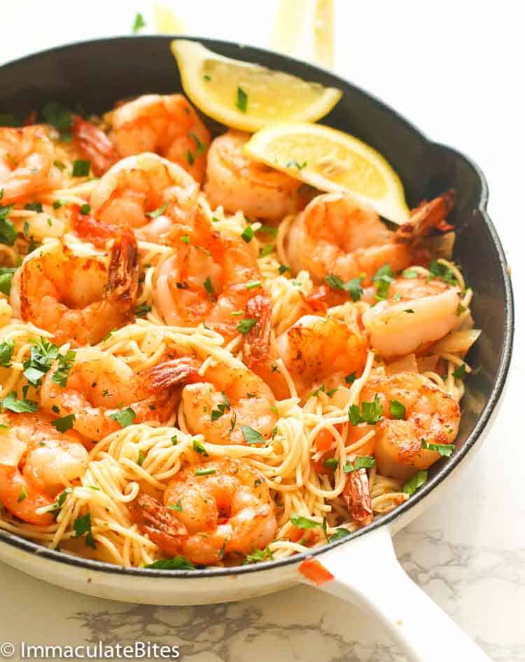 A Skillet of Shrimp Scampi Pasta Served with Lemon Slices