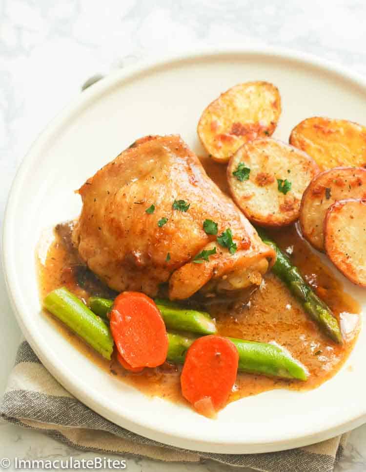 Chicken fricassee plated with carrots and green beans with fried potatoes