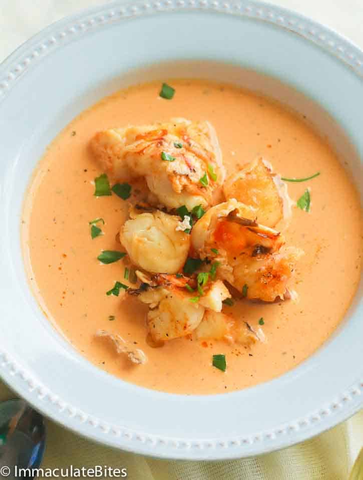 a serving of lobster bisque in a classy white bowl