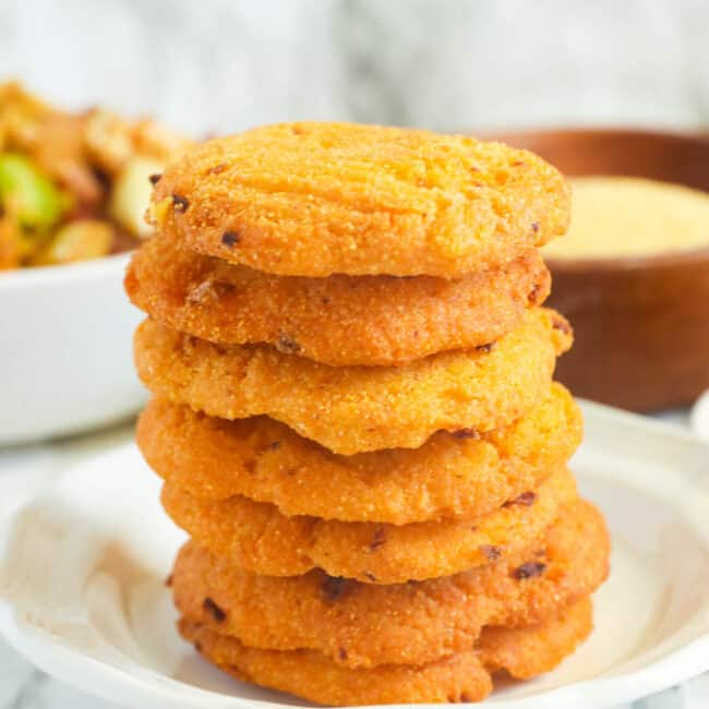 a stack of hot water cornbread on a plate