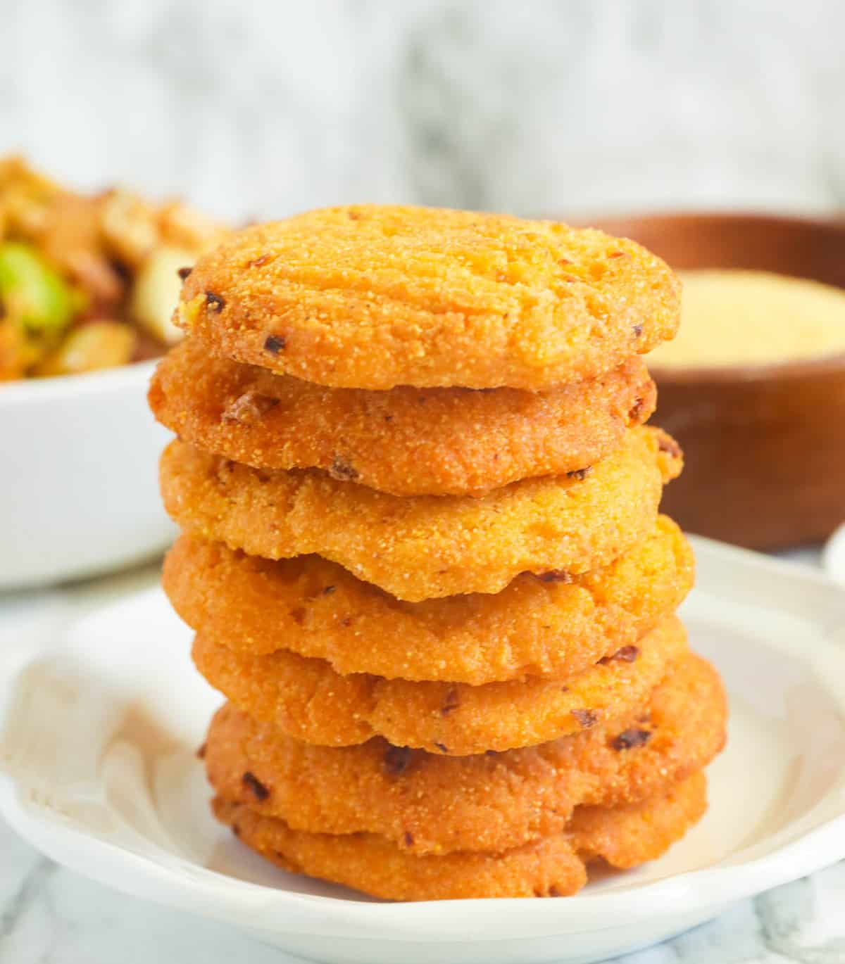 a stack of hot water cornbread on a plate