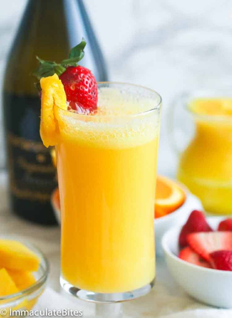 Refreshing Mimosa cocktail with a strawberry and pineapple slice for Mother's Day or any other special occasion