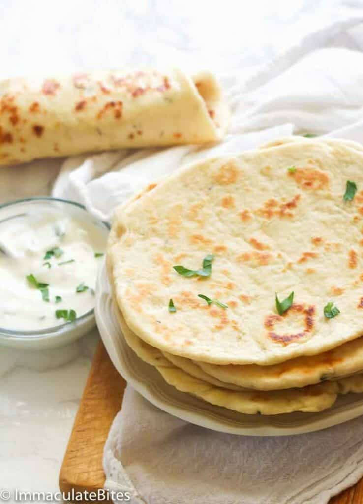 Insanely comforting flatbread ready to enjoy with a yogurt sauce