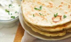 Insanely comforting flatbread ready to enjoy with a yogurt sauce