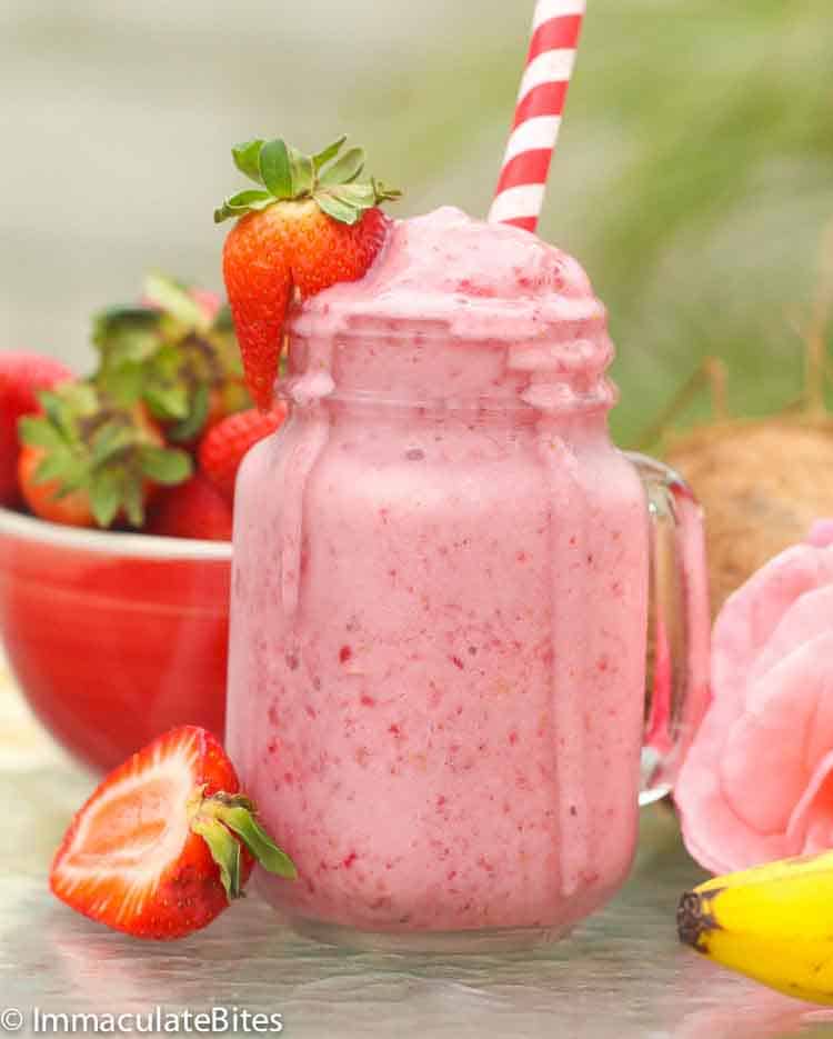 Strawberry Smoothie overflowing a mason jar glass