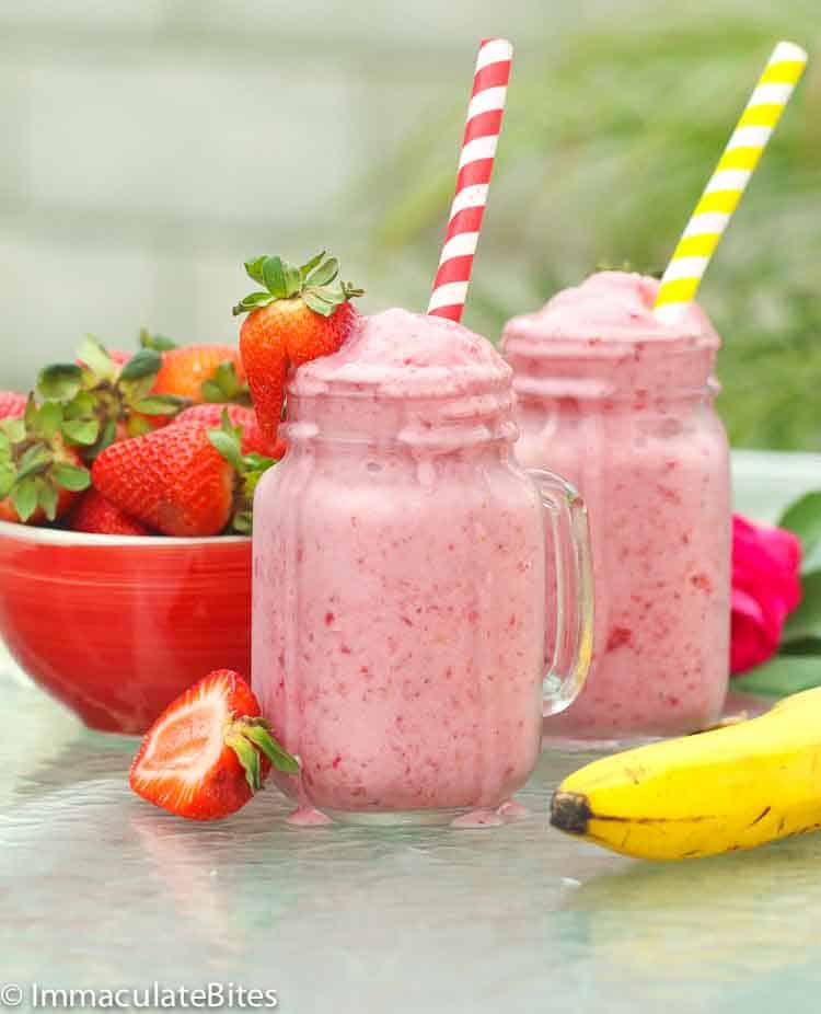 Brunch beverage - 2 glasses of strawberry banana smoothie with a bowl of fresh strawberries