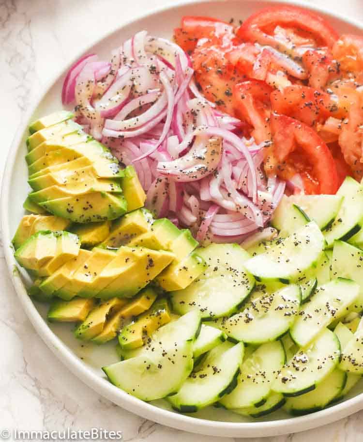 A plate full of cucumber tomato salad