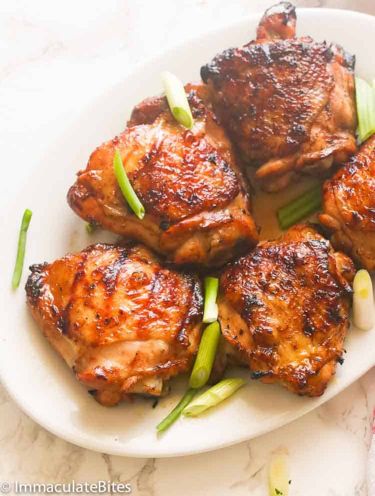 A Plate of Hawaiian Grilled Chicken Thighs Garnished with Sliced Spring Onions