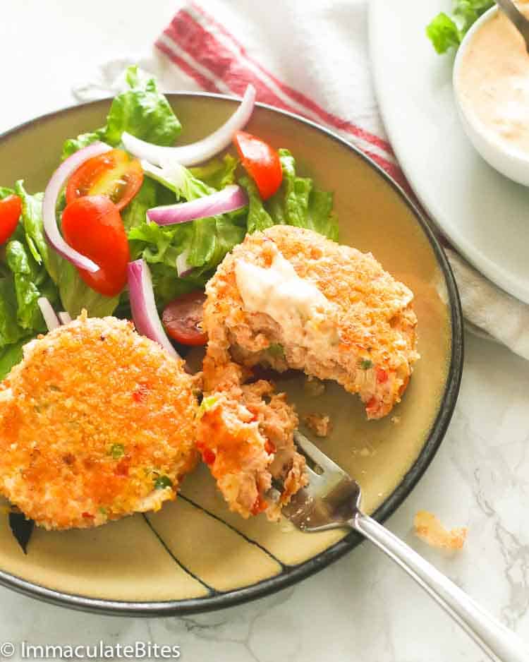 Enjoying a forkful of Salmon Patties with a refreshing side salad