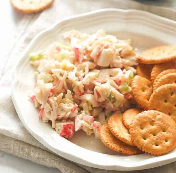 Enjoying imitation crab salad with crackers for an easy appetizer