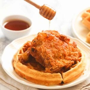 Drizzling delectable Chicken and Waffles with syrup