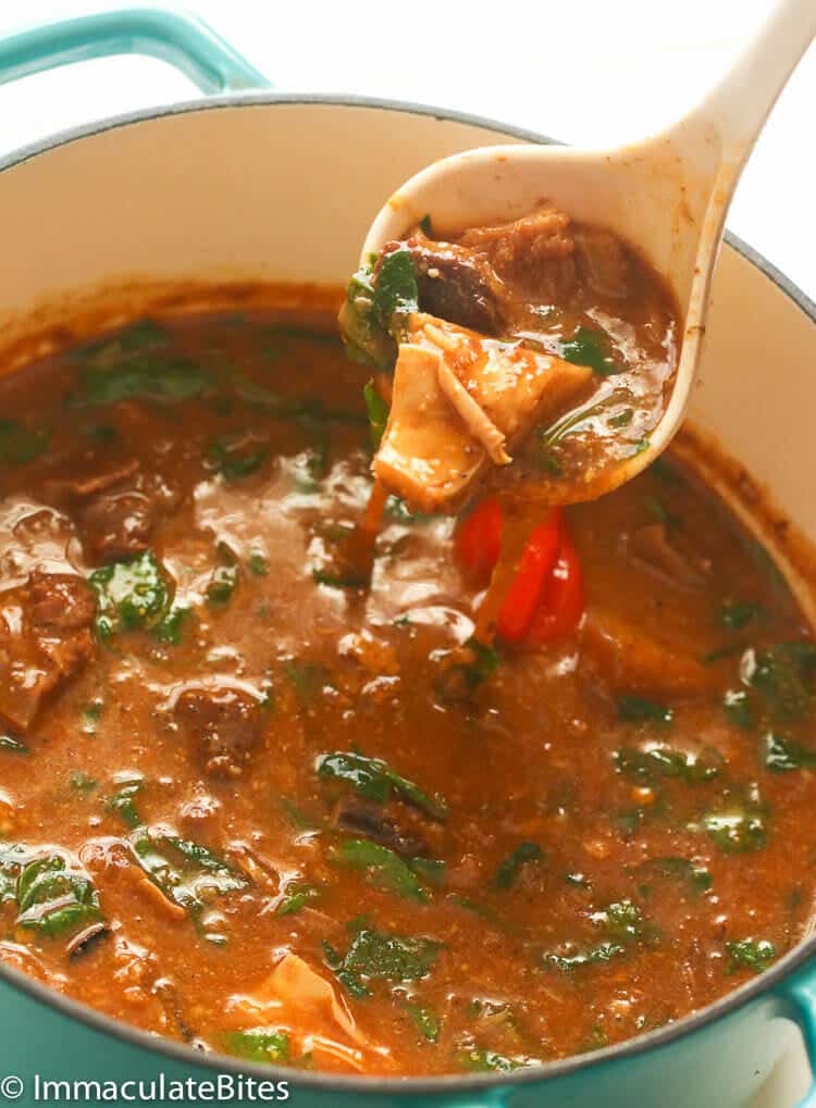 Ogbono Soup with a spoonful ready to go into a bowl.