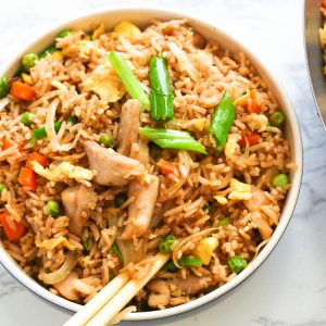 A Bowl of Chicken Fried Rice Topped with Slices of Green Onions